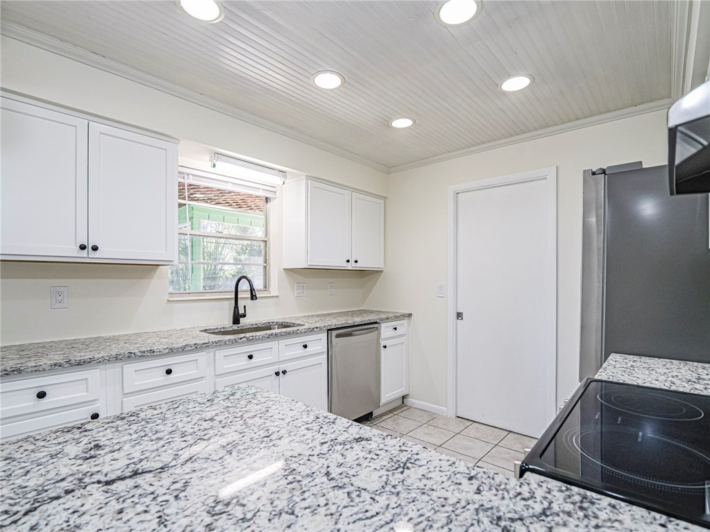 1331 Barber Street Sebastian, FL 32958 - Photo 9 of 32 a kitchen with a sink stove and cabinets