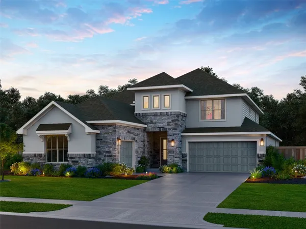a front view of a house with a garden and yard