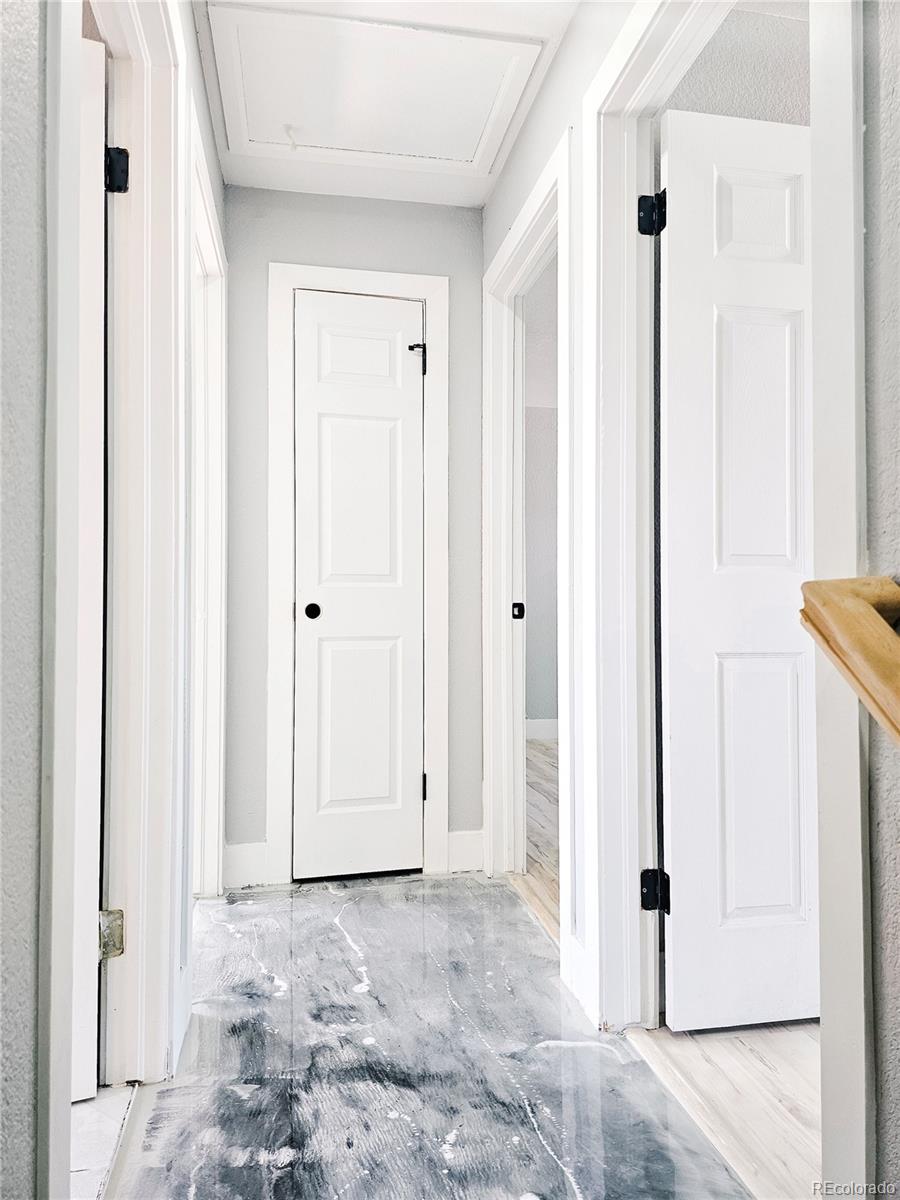 4716 Freeport Way Denver, CO 80239 - Photo 7 of 29 a view of a bedroom with wooden floor and bathroom