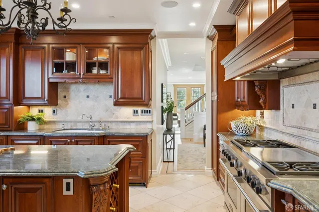a stove top oven sitting inside of a kitchen