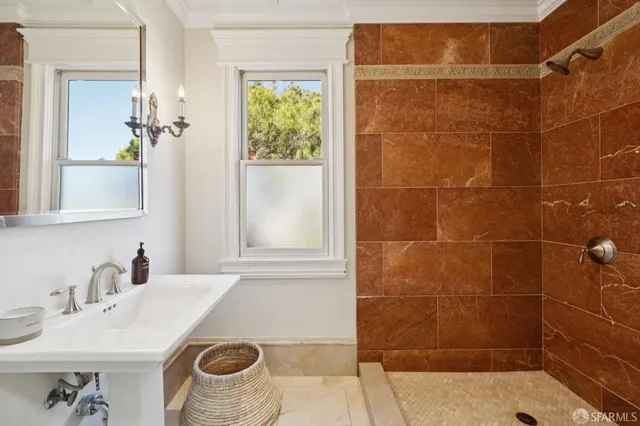 a bathroom with a granite countertop tub sink and mirror