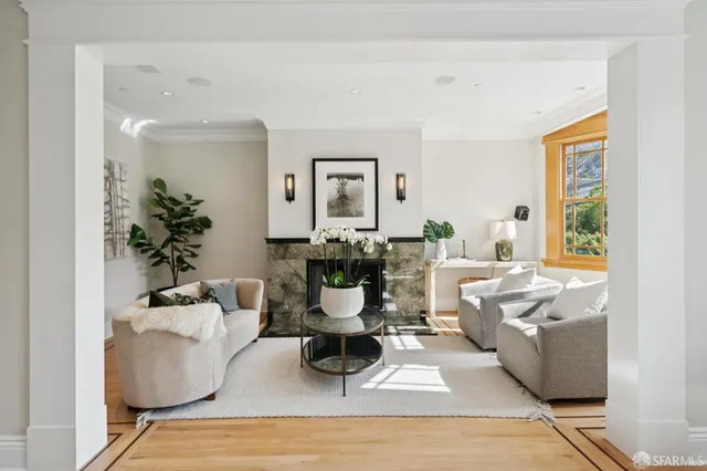 a view of a room with furniture and wooden floor