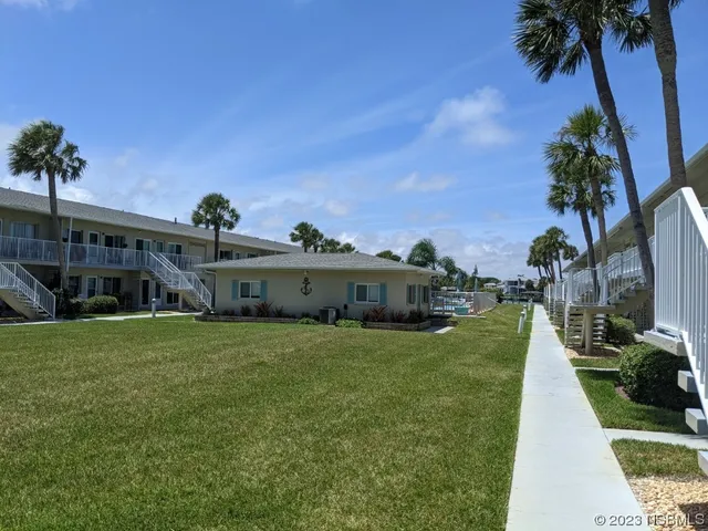 a view of a garden with lawn chairs