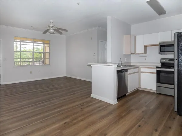 a kitchen with wooden floors and white appliances