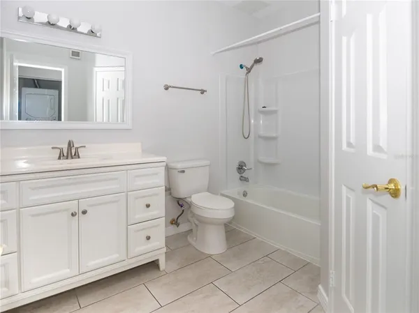 a bathroom with a double vanity sink toilet mirror and shower