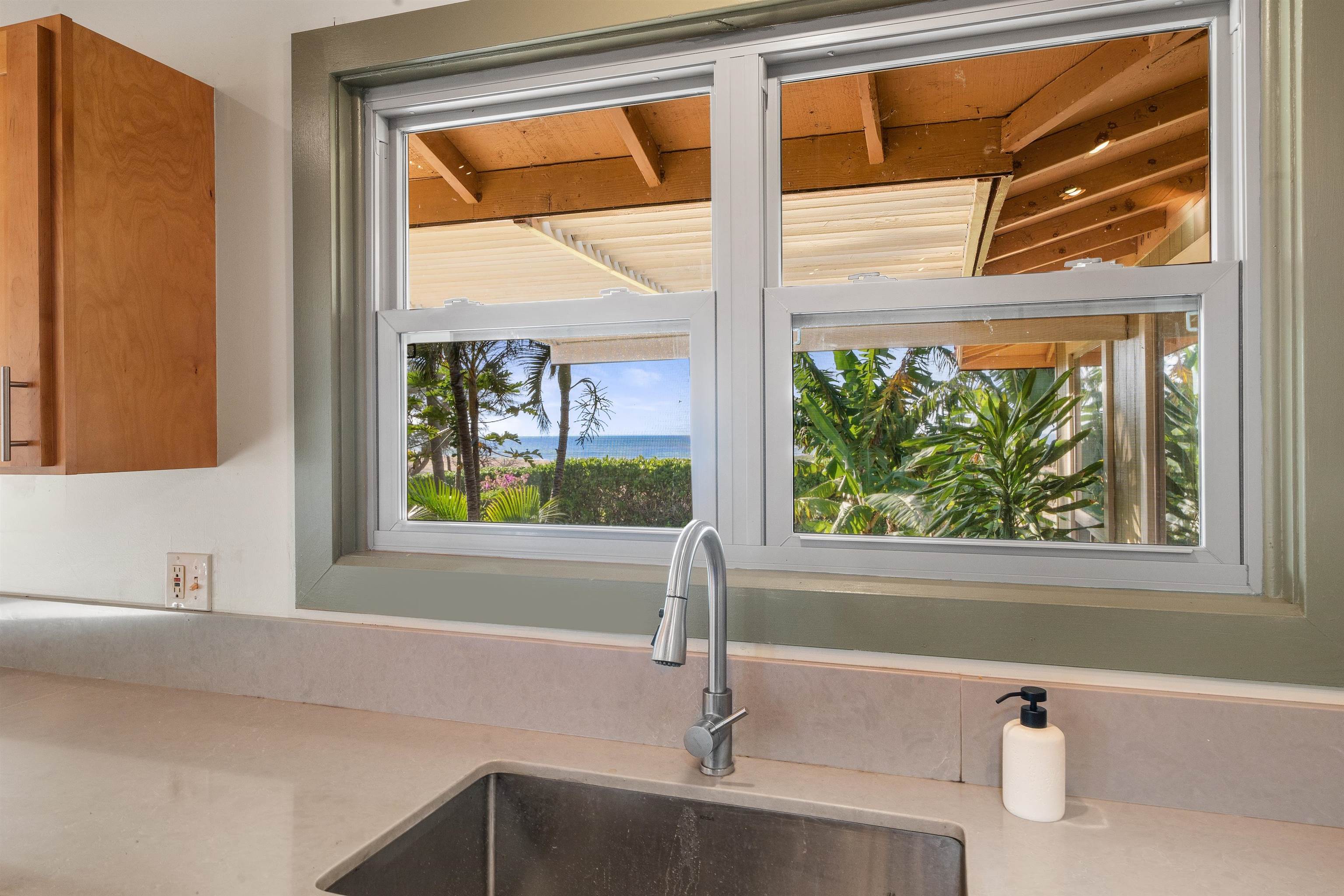 2944 Kalua Koi Road Maunaloa, HI 96770 - Photo 12 of 47 a bathroom with a bathtub and next to a window
