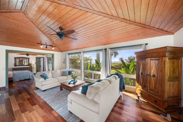 a living room with furniture a ceiling fan and a rug