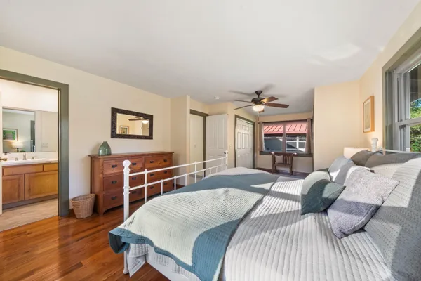 a bedroom with furniture and a wooden floor
