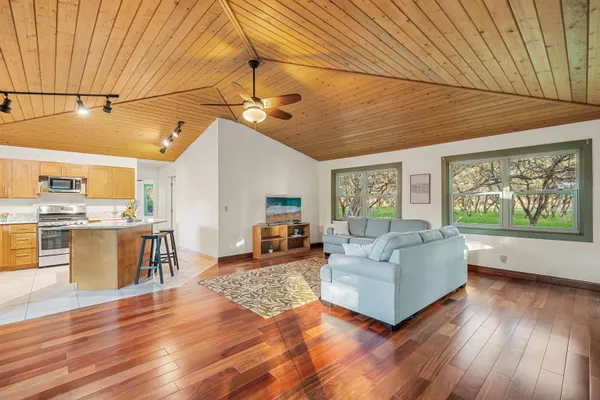 a living room with furniture and wooden floor