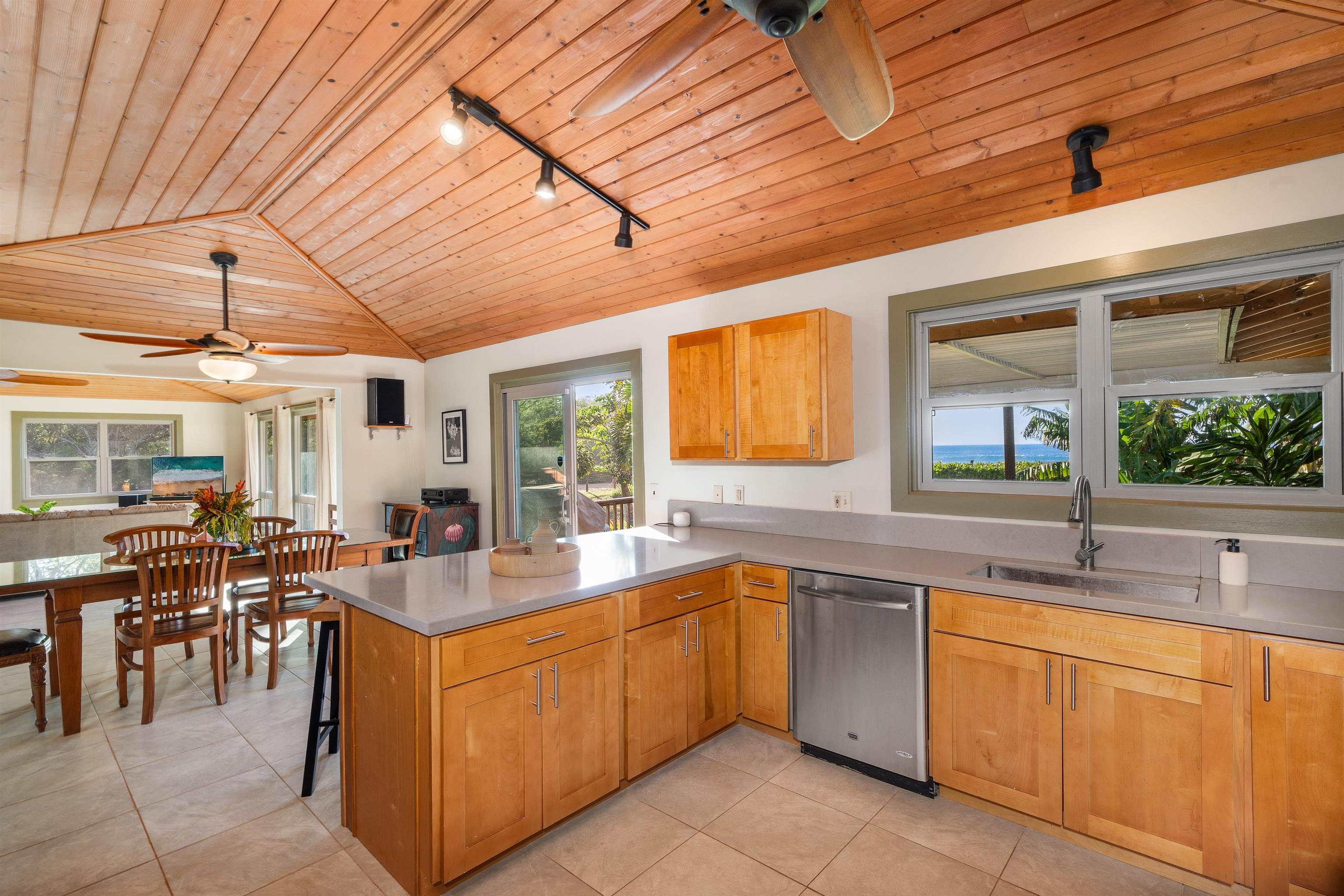 2944 Kalua Koi Road Maunaloa, HI 96770 - Photo 10 of 47 a kitchen with sink a counter and chairs