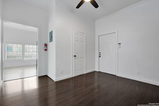 an empty room with wooden floor and window