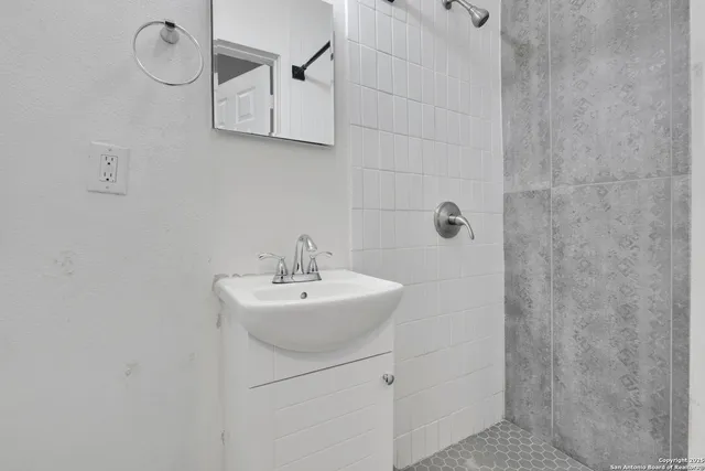 a bathroom with a sink a mirror and vanity