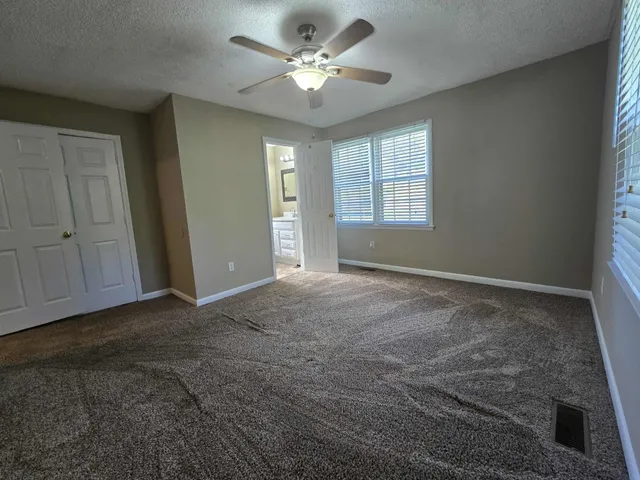 a view of a livingroom with a ceiling fan and window