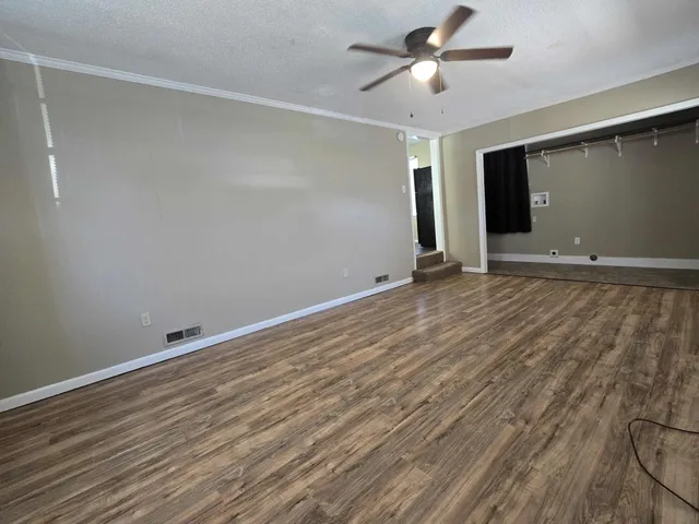 a view of room with window and ceiling fan