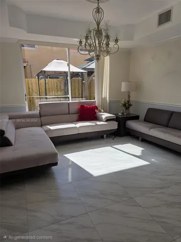 a living room with furniture and a chandelier