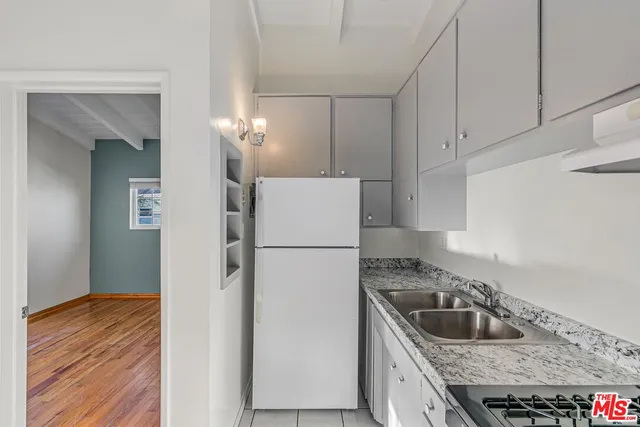 a kitchen with a refrigerator sink and stove