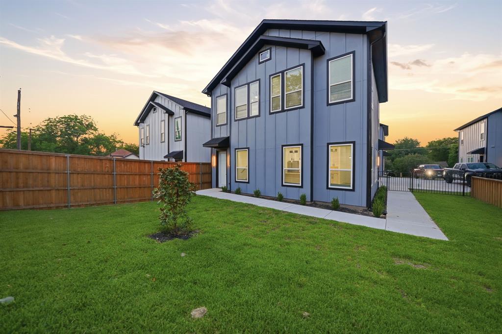 306 East 7th Street Dallas, TX 75203 - Photo 2 of 22 Modern two-story residence featuring a blue vertical siding exterior, black trim windows, and a prominent black roofline