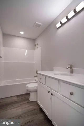 a bathroom with a sink a toilet and bathtub
