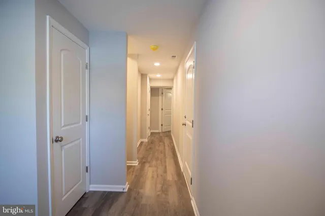 a view of a hallway with wooden floor