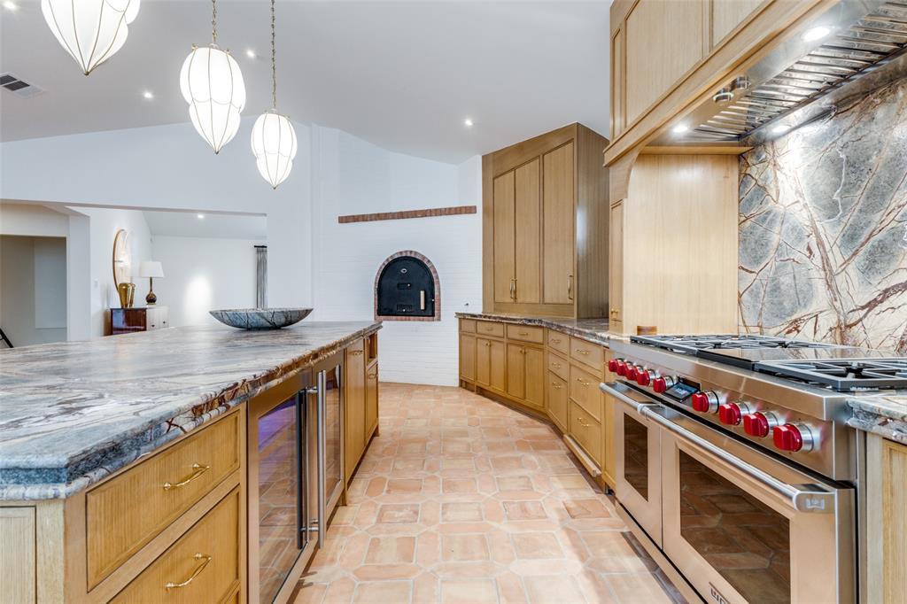 1308 San Rafael Drive Dallas, TX 75218 - Photo 16 of 40 a kitchen with stove a sink and cabinets