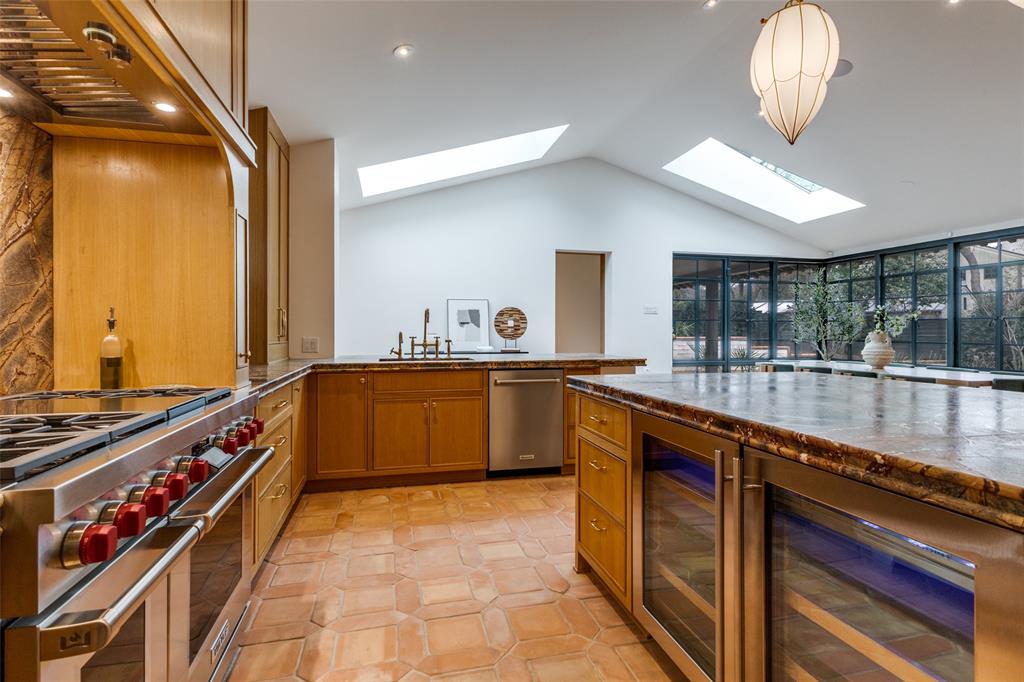 1308 San Rafael Drive Dallas, TX 75218 - Photo 17 of 40 a large kitchen with stainless steel appliances a large counter top a stove and a sink