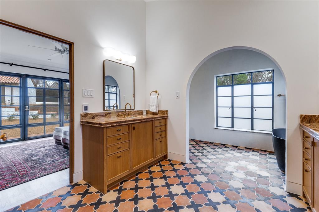 1308 San Rafael Drive Dallas, TX 75218 - Photo 27 of 40 a spacious bathroom with a granite countertop sink a mirror and a shower