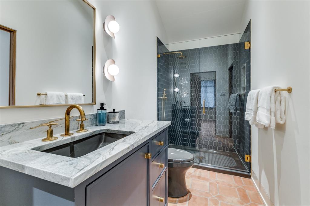 1308 San Rafael Drive Dallas, TX 75218 - Photo 31 of 40 a bathroom with a sink a toilet and shower