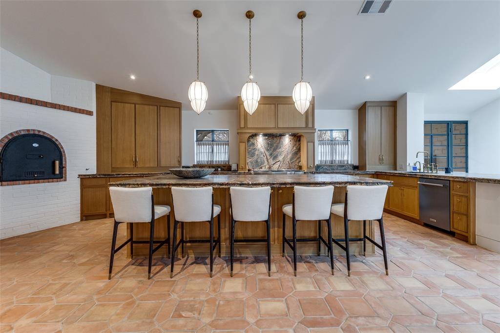 1308 San Rafael Drive Dallas, TX 75218 - Photo 8 of 40 a kitchen with a dining table chairs and cabinets