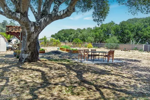an outdoor space with furniture and garden