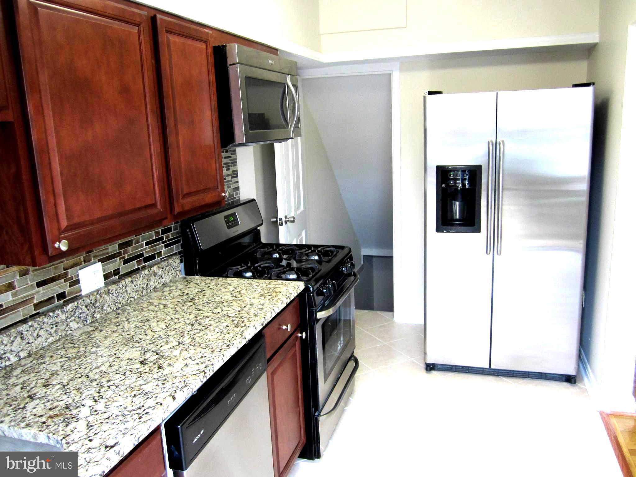 642 Brisbane Road Baltimore, MD 21229 - Photo 3 of 16 a kitchen with a refrigerator and a stove