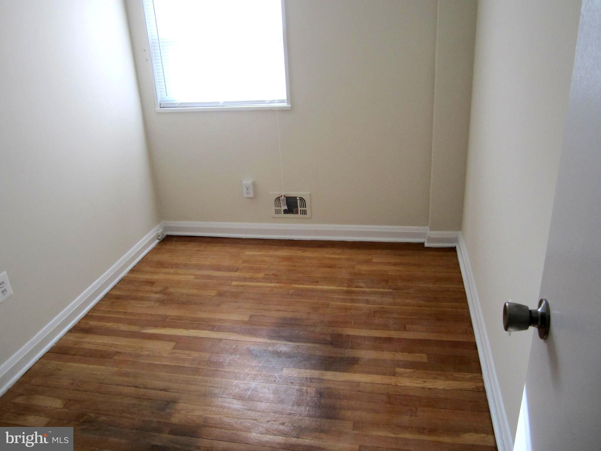 642 Brisbane Road Baltimore, MD 21229 - Photo 6 of 16 a view of a room with wooden floor and a window