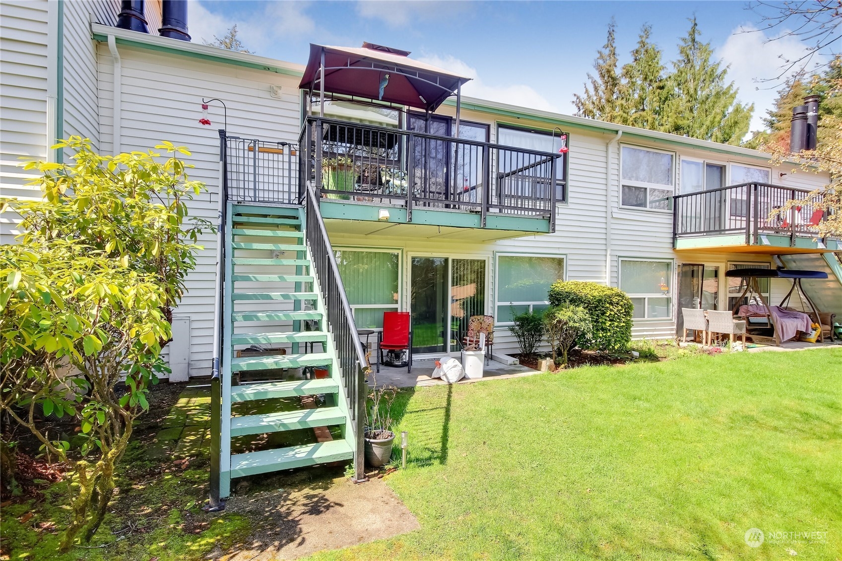 2003 Southwest 318th Place, Unit D8 Federal Way, WA 98023 - Photo 1 of 35 a view of a chairs and tables in the back yard of the house
