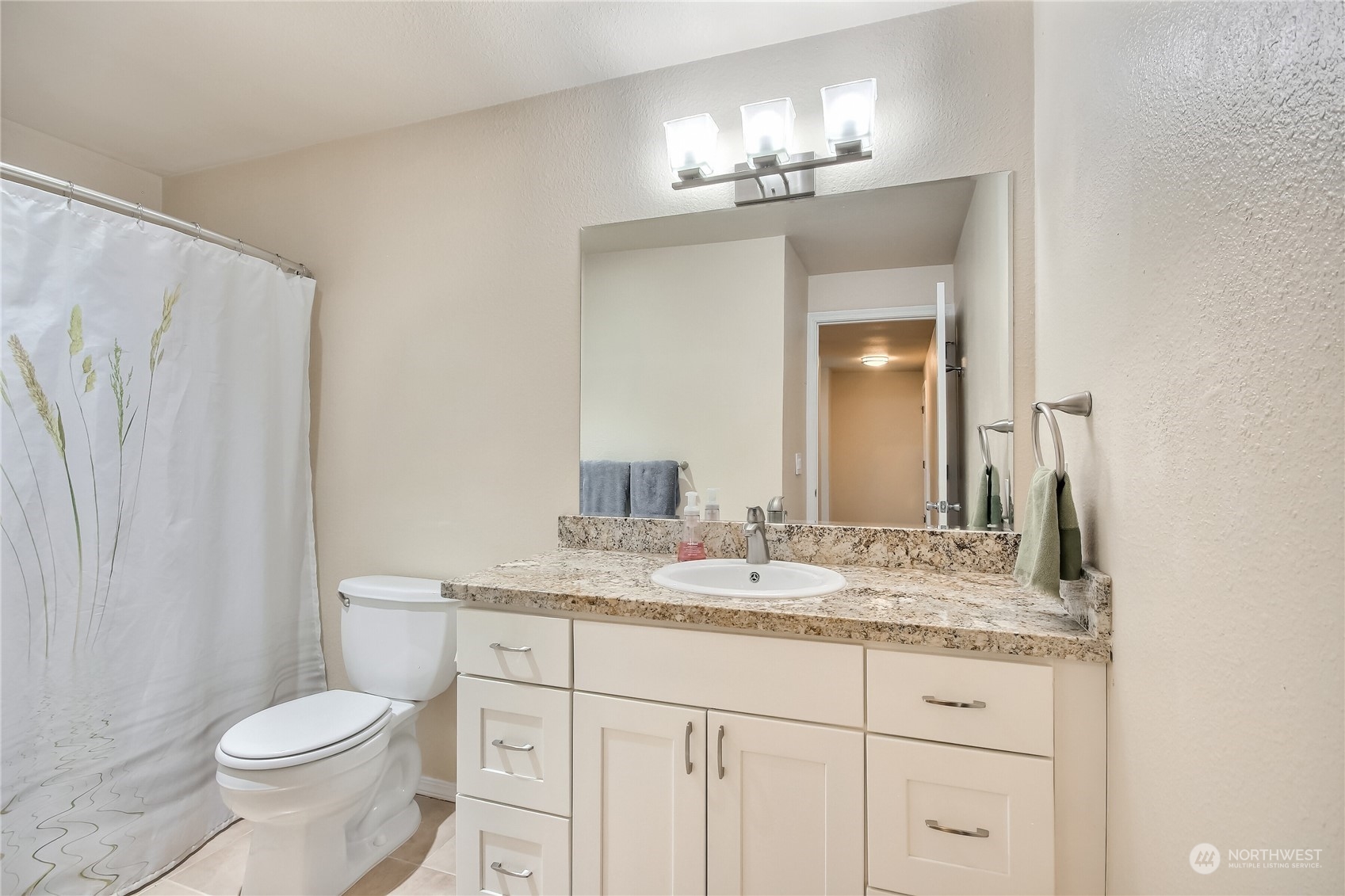 2003 Southwest 318th Place, Unit D8 Federal Way, WA 98023 - Photo 11 of 35 a bathroom with a granite countertop sink toilet and mirror