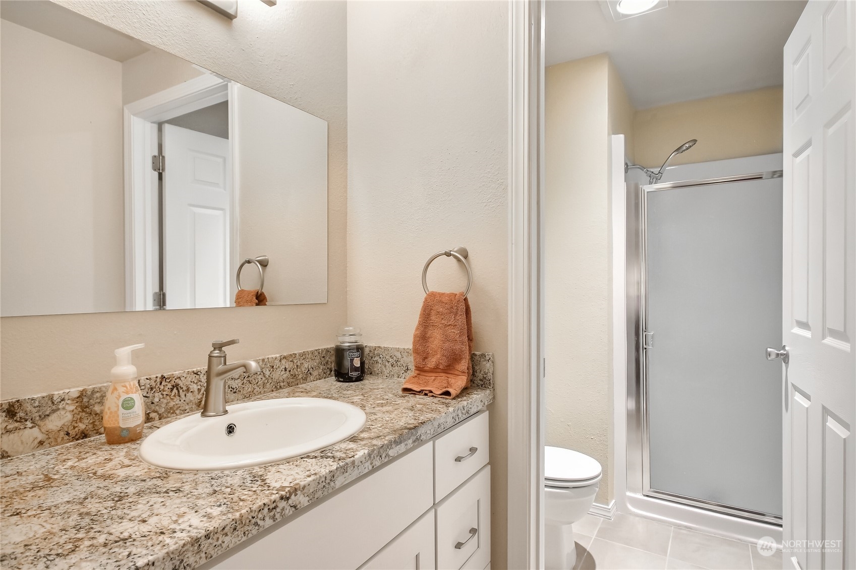 2003 Southwest 318th Place, Unit D8 Federal Way, WA 98023 - Photo 14 of 35 a bathroom with a granite countertop sink and a mirror