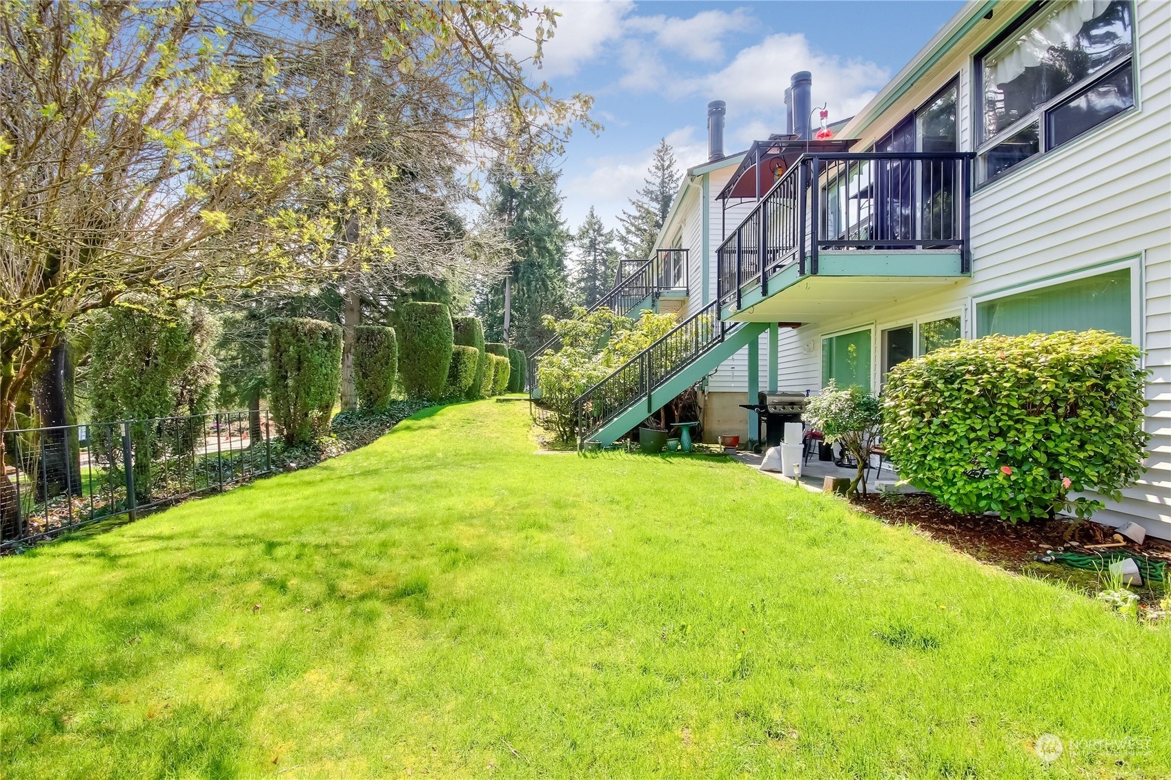 2003 Southwest 318th Place, Unit D8 Federal Way, WA 98023 - Photo 20 of 35 a view of a house with a yard table and chairs