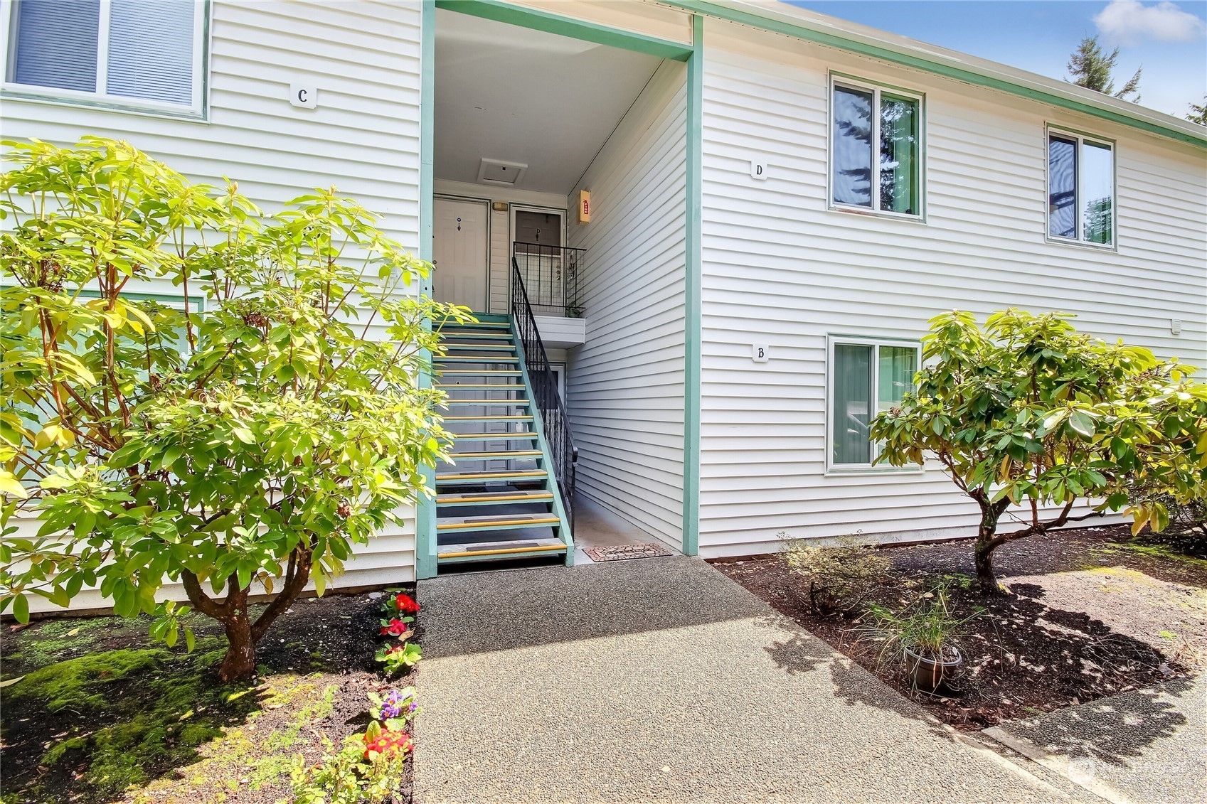 2003 Southwest 318th Place, Unit D8 Federal Way, WA 98023 - Photo 3 of 35 a potted plant sitting in front of a house