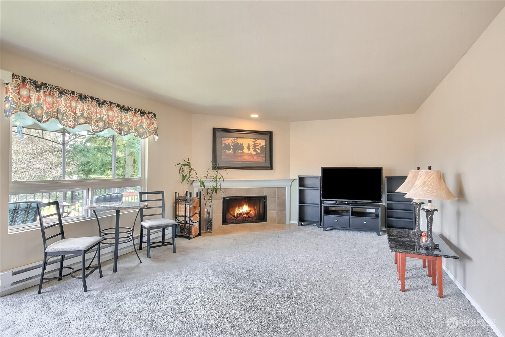 2003 Southwest 318th Place, Unit D8 Federal Way, WA 98023 - Photo 4 of 35 a living room with furniture a flat screen tv and a fireplace