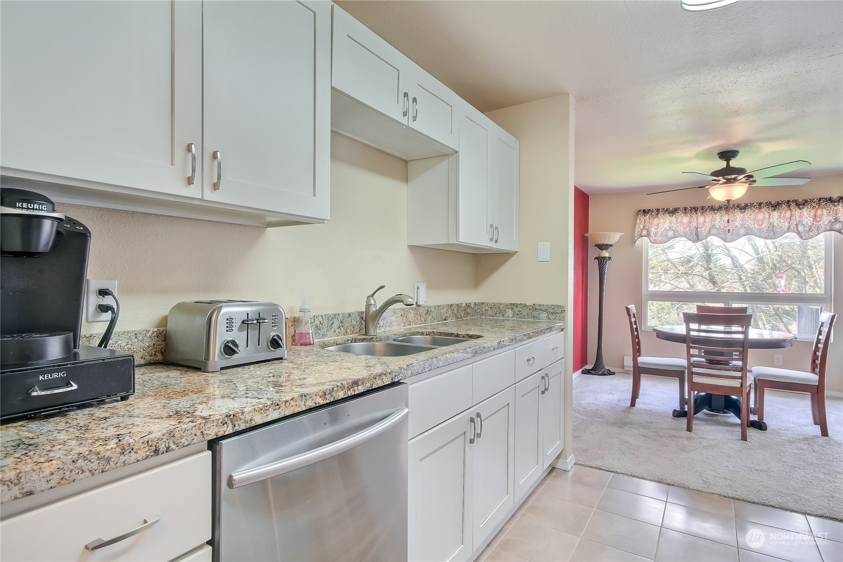 2003 Southwest 318th Place, Unit D8 Federal Way, WA 98023 - Photo 9 of 35 a kitchen with granite countertop a sink stove and cabinets