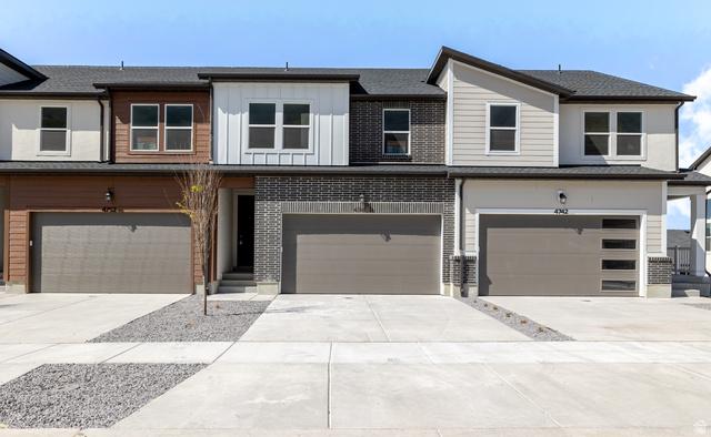 4748 Heartwood Road, Unit 434 Mapleton, UT 84664 - Photo 2 of 18 View of front of property featuring concrete driveway, a garage, and board and batten siding