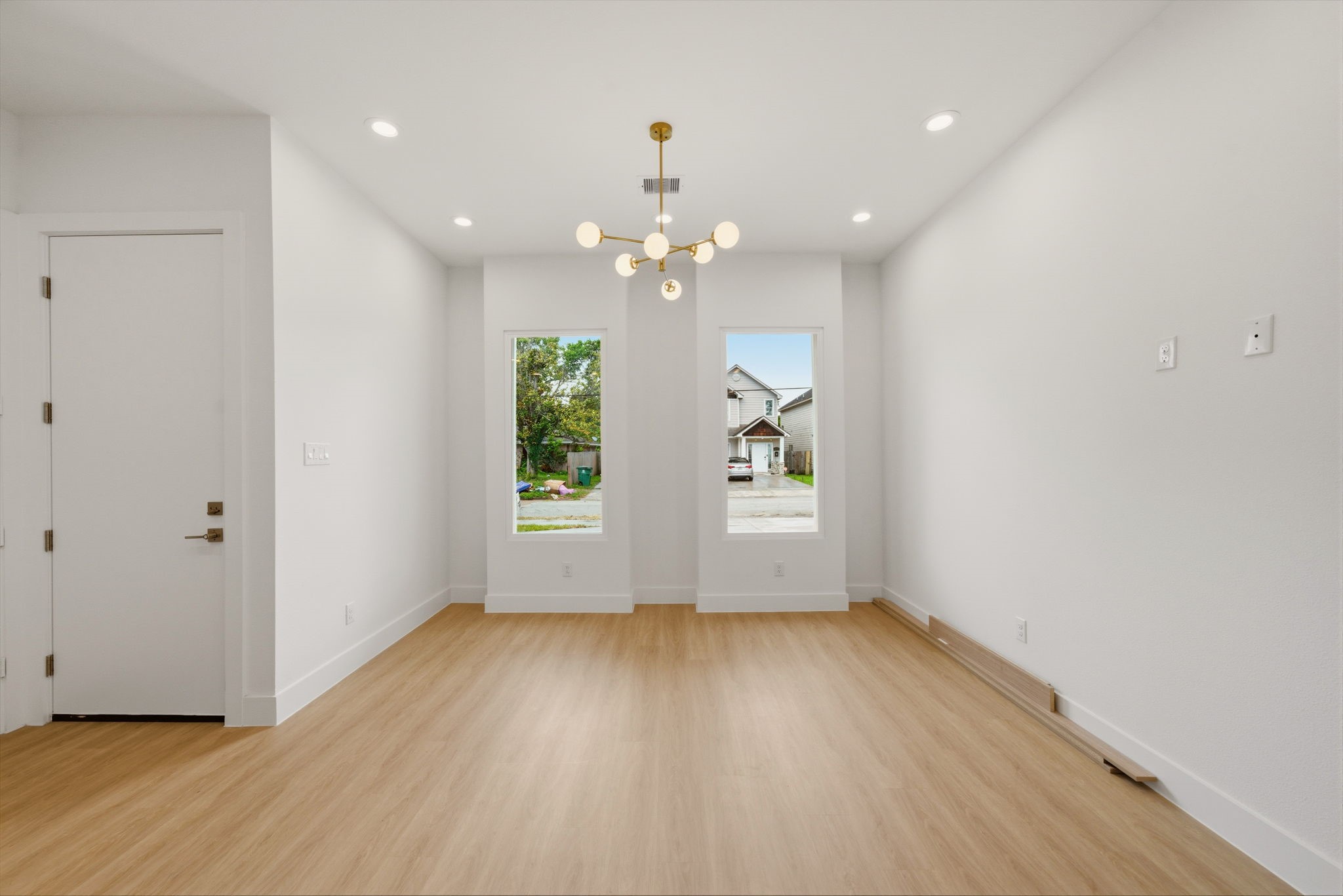 6514 Luce Street Houston, TX 77087 - Photo 18 of 34 an empty room with wooden floor and windows