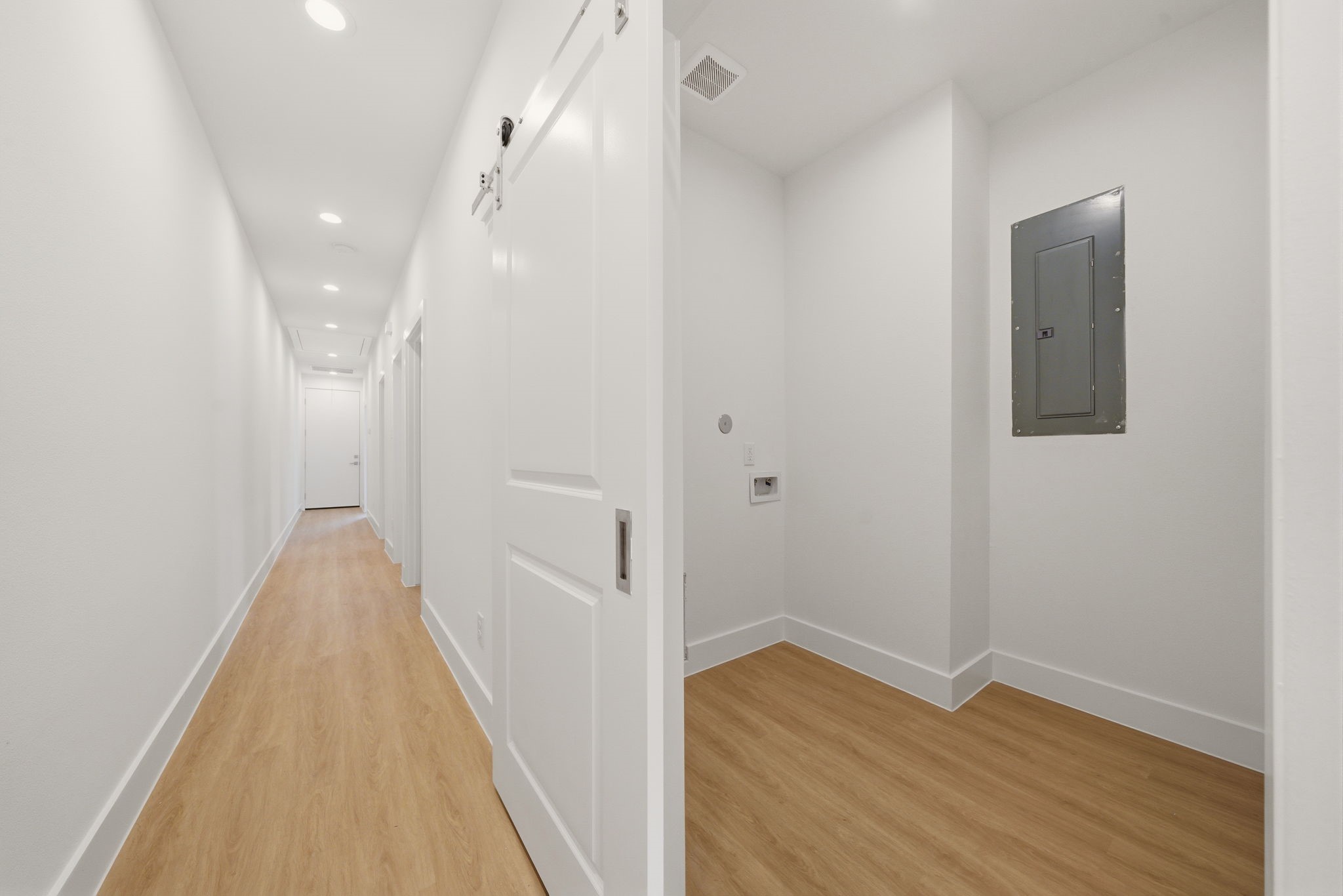 6514 Luce Street Houston, TX 77087 - Photo 19 of 34 a view of a hallway with wooden floor and staircase