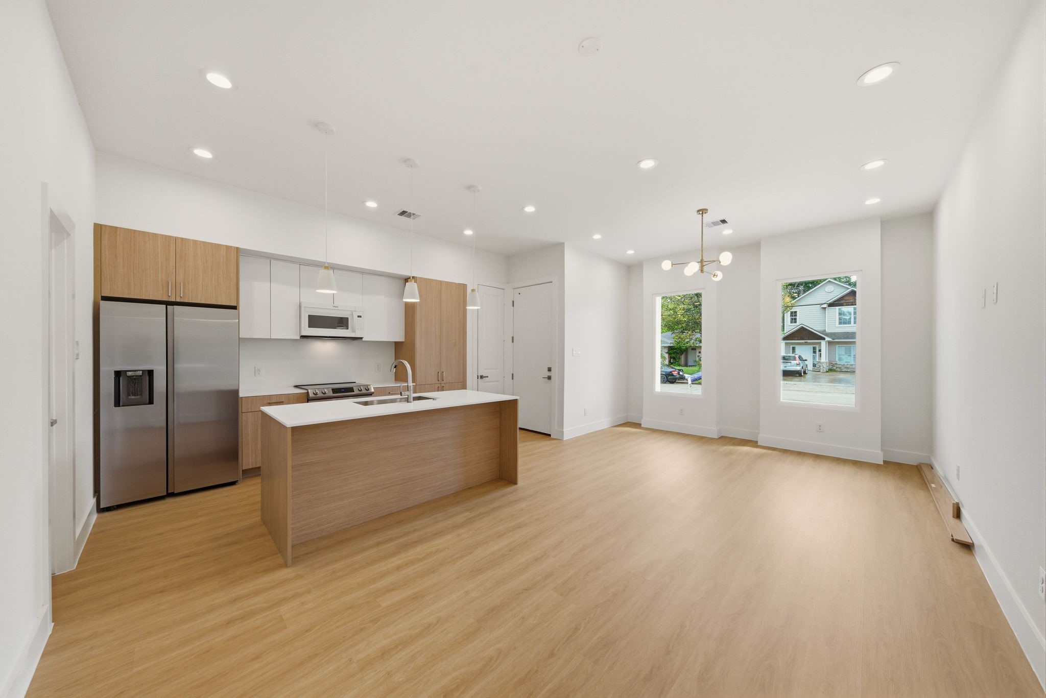 6514 Luce Street Houston, TX 77087 - Photo 20 of 34 a large kitchen with stainless steel appliances kitchen island a large counter top and a refrigerator