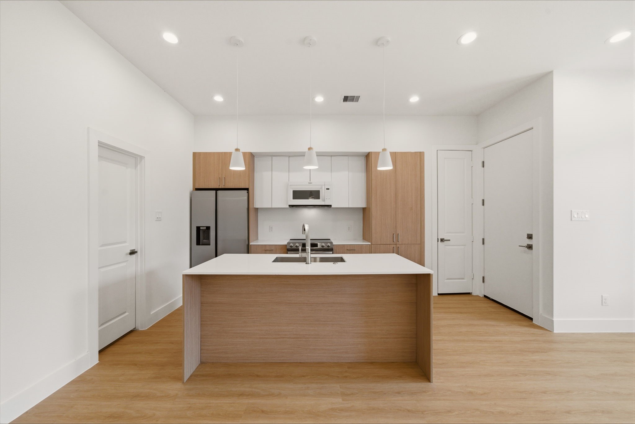 6514 Luce Street Houston, TX 77087 - Photo 21 of 34 a view of kitchen with kitchen island a sink wooden floor and stainless steel appliances