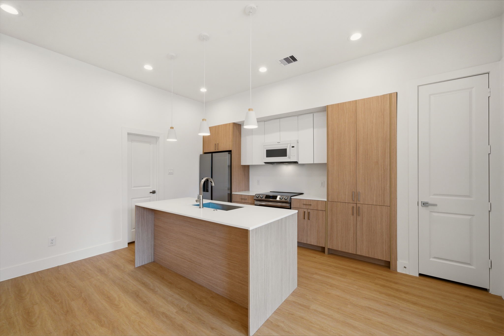 6514 Luce Street Houston, TX 77087 - Photo 22 of 34 a kitchen with stainless steel appliances a sink a stove a refrigerator and cabinets