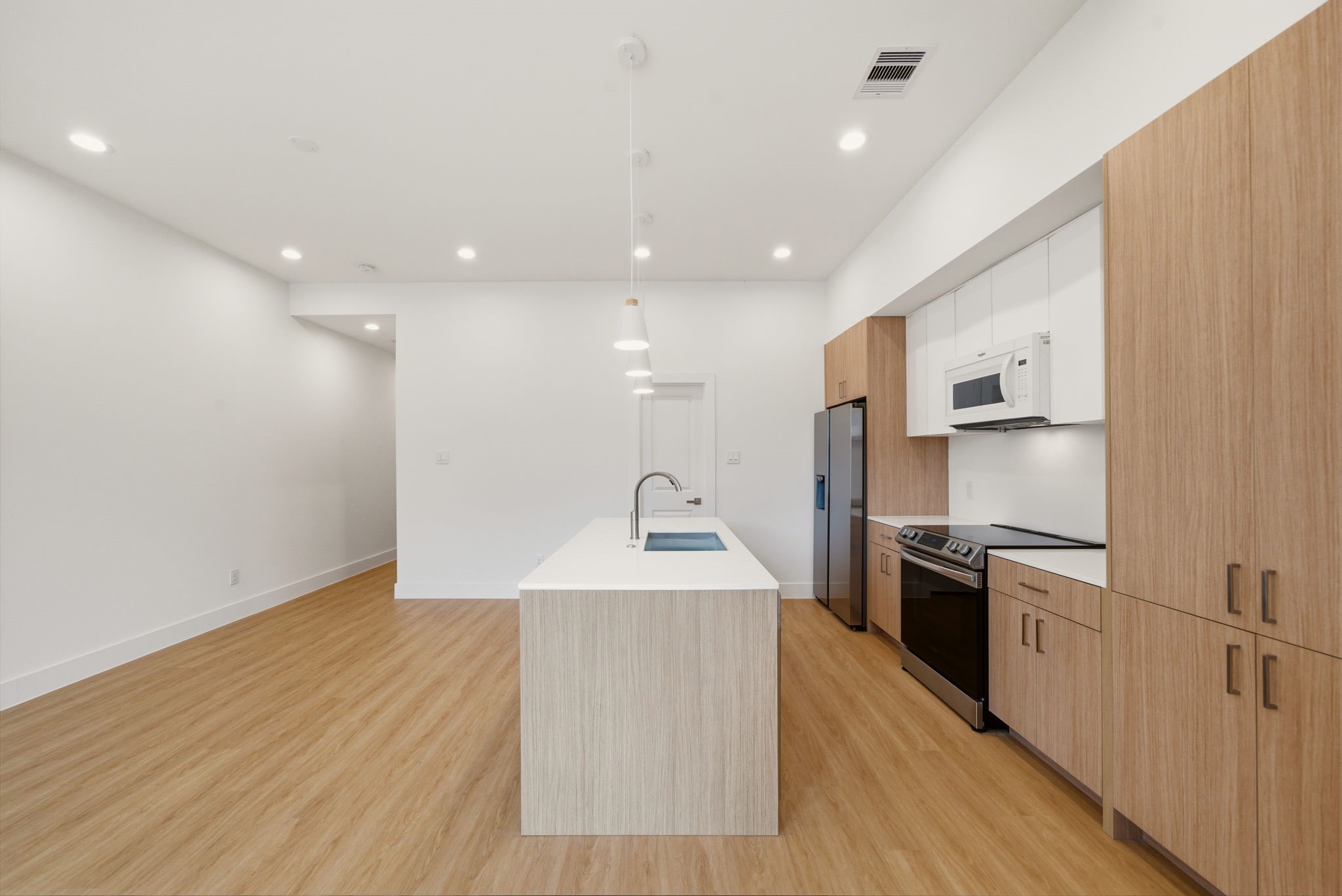 6514 Luce Street Houston, TX 77087 - Photo 23 of 34 a kitchen with stainless steel appliances granite countertop a sink a stove a refrigerator and a microwave