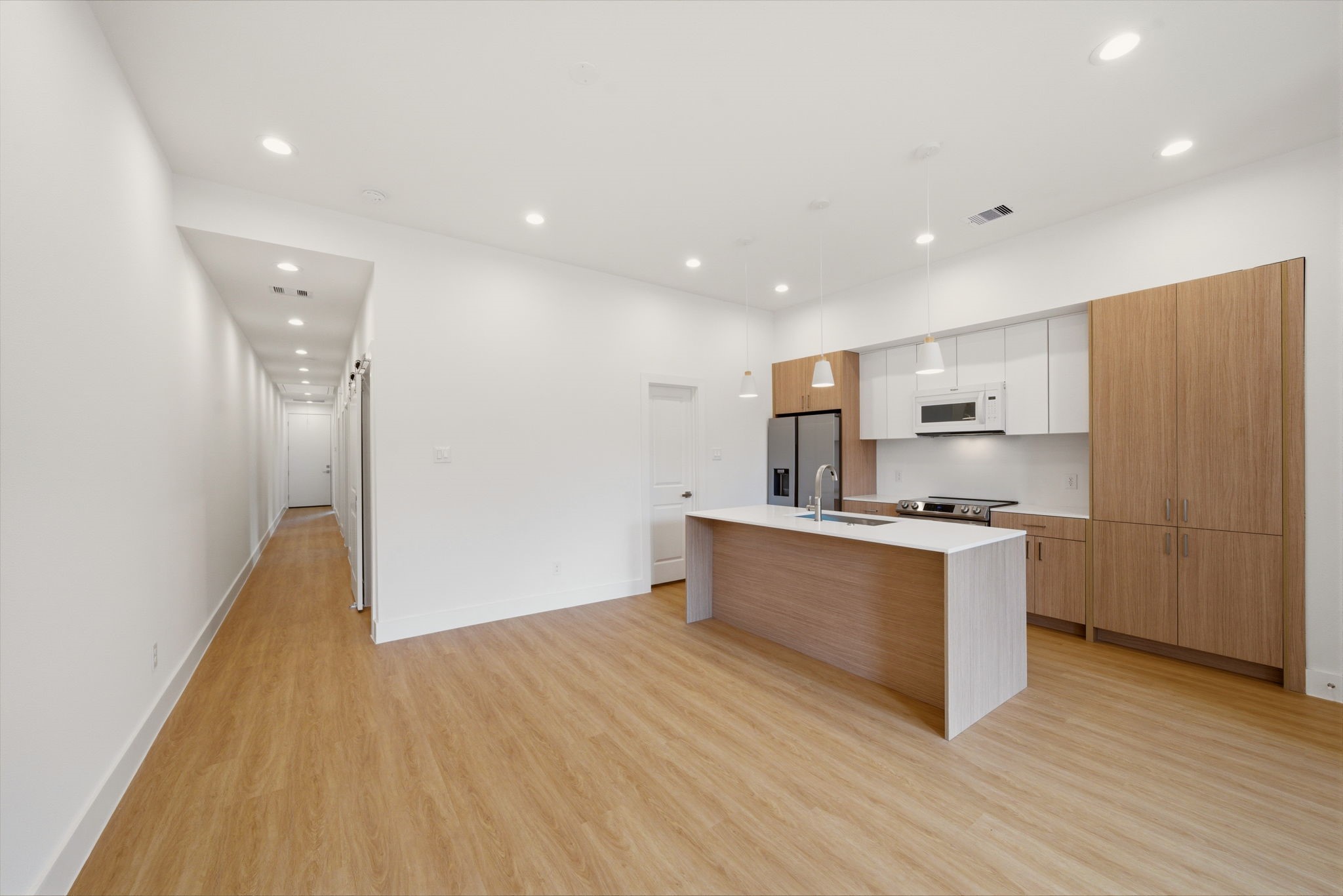 6514 Luce Street Houston, TX 77087 - Photo 24 of 34 a large kitchen with stainless steel appliances a refrigerator and a stove top oven