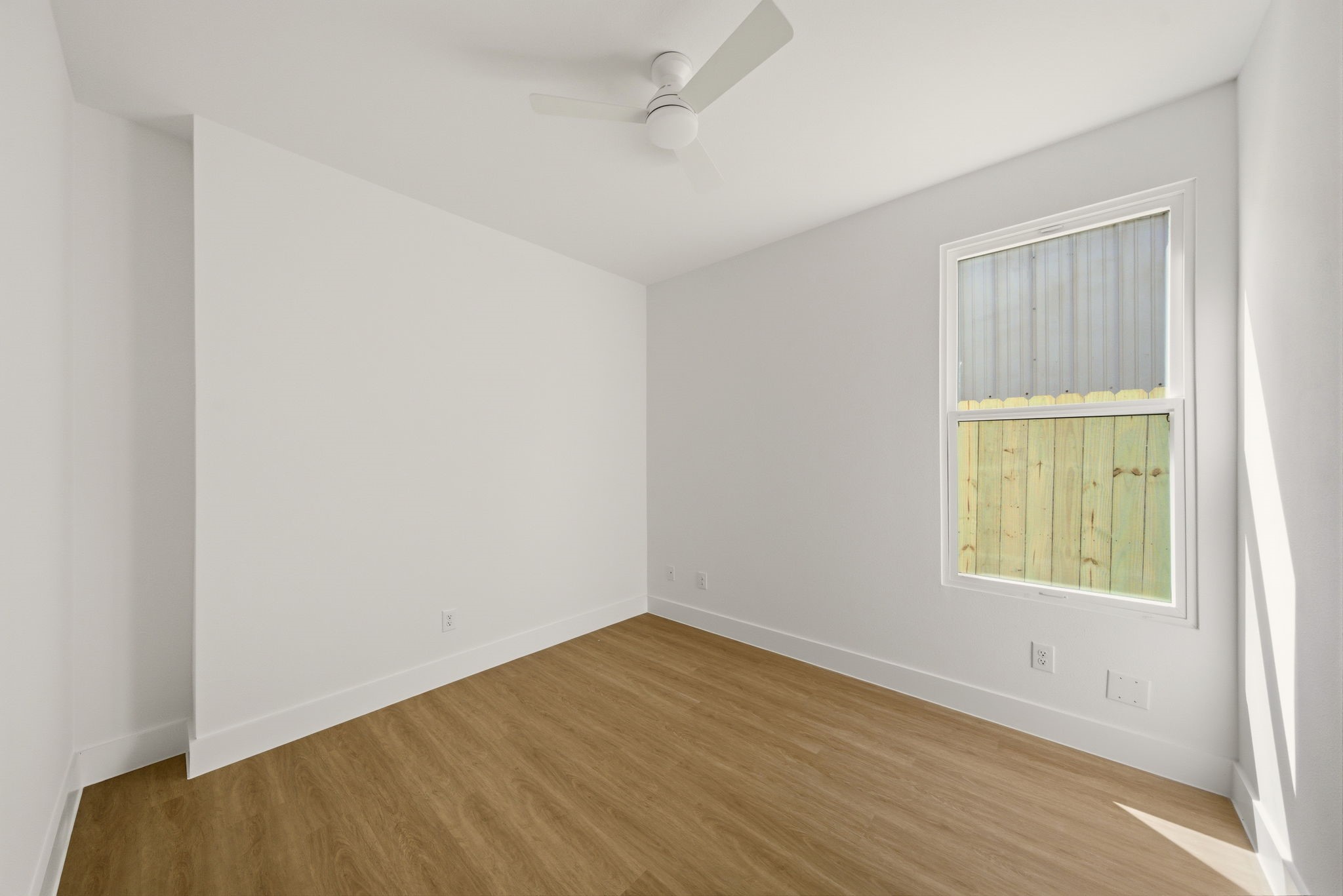 6514 Luce Street Houston, TX 77087 - Photo 26 of 34 an empty room with wooden floor and windows