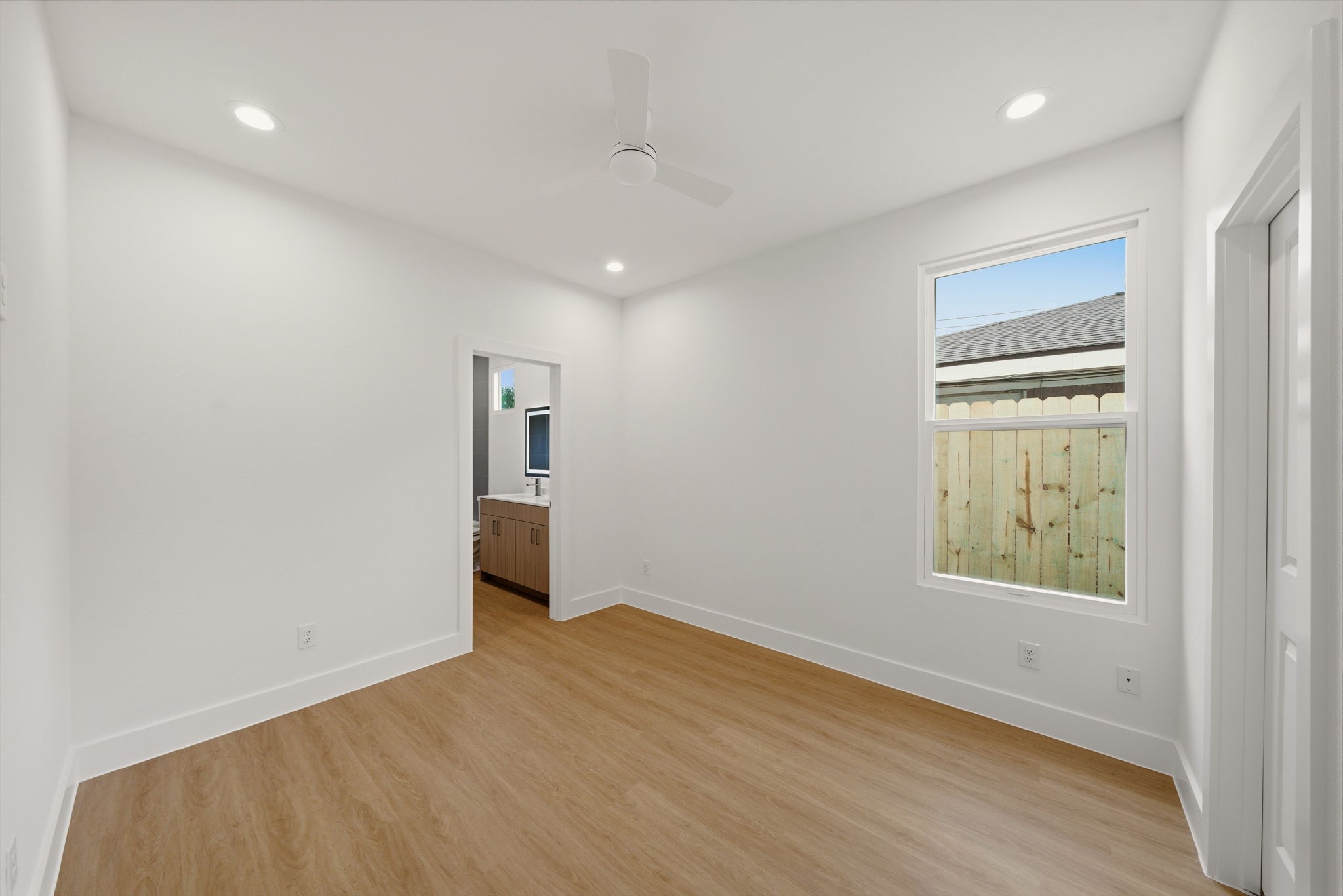 6514 Luce Street Houston, TX 77087 - Photo 28 of 34 an empty room with wooden floor and windows