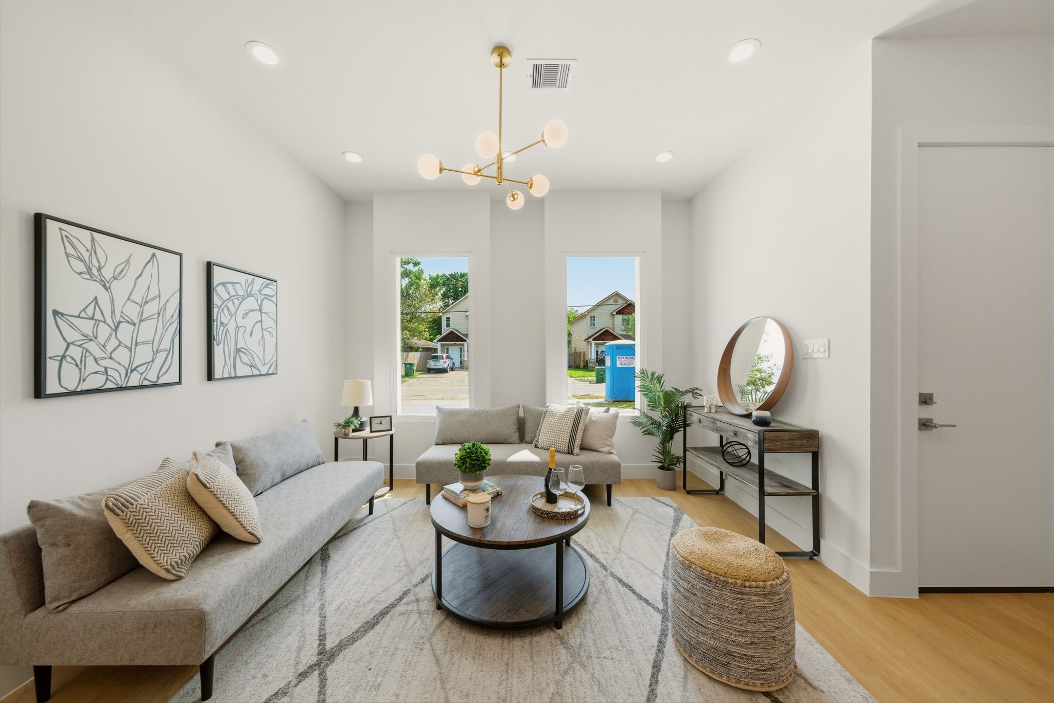 6514 Luce Street Houston, TX 77087 - Photo 5 of 34 a living room with furniture a rug and a chandelier