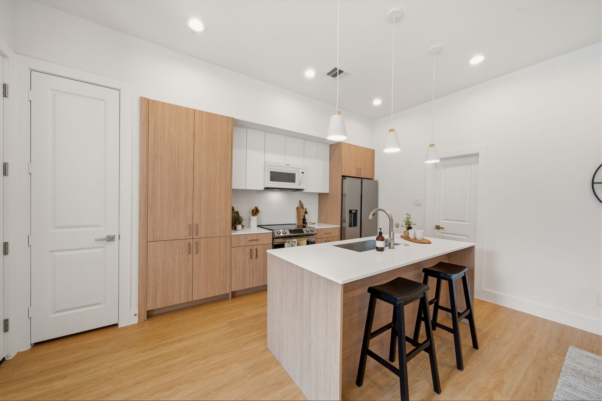 6514 Luce Street Houston, TX 77087 - Photo 8 of 34 a kitchen with a sink a refrigerator and cabinets